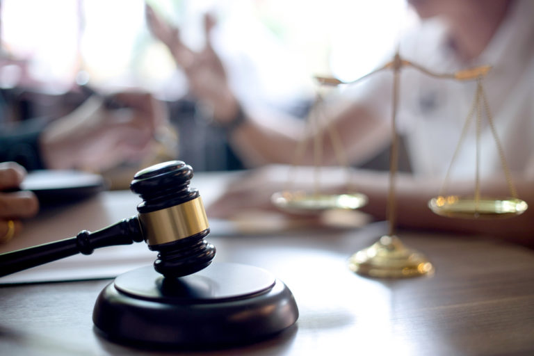 Close-up of gavel and scales during an estate planning consultation.